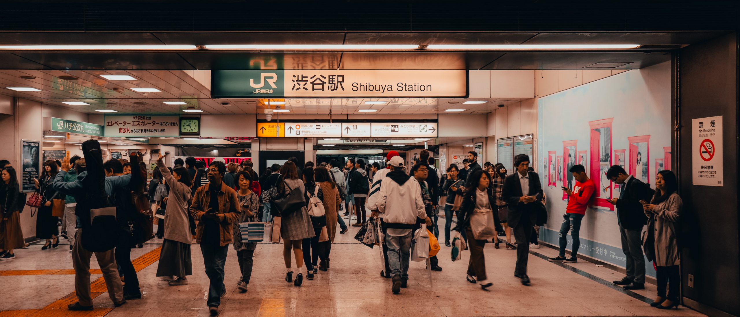 People walking through a train station in Tokyo